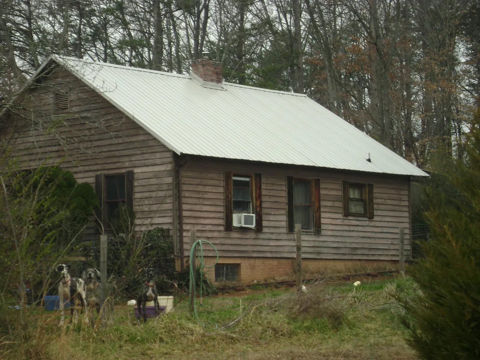 White metal roof on an old wood sided farmhouse, from a Metal Roof Installation job in Brownsville